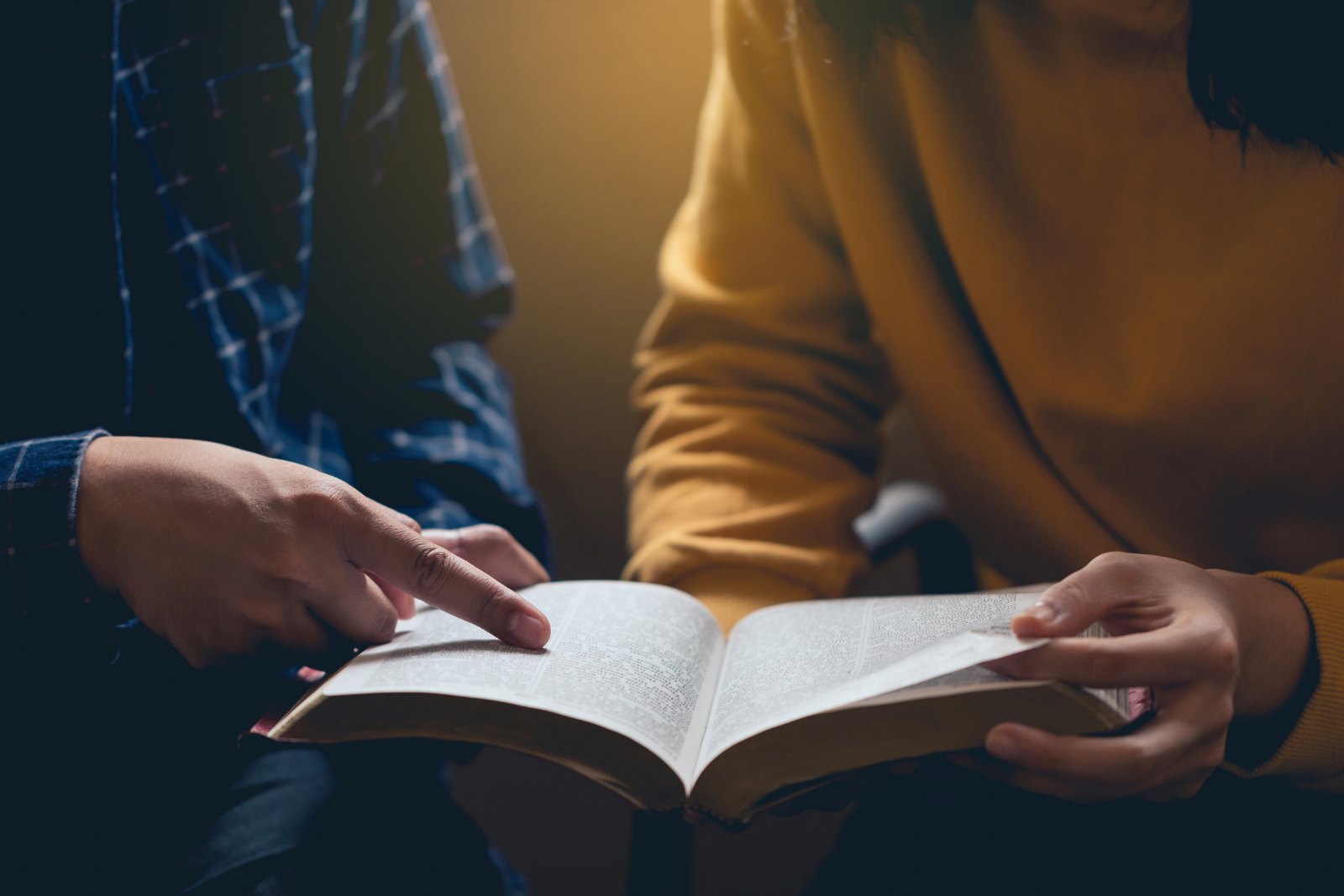 Young adults around an open Bible